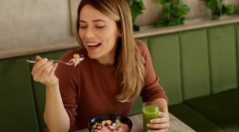 person eating fruit bowl