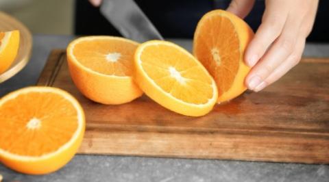 Woman cutting oranges